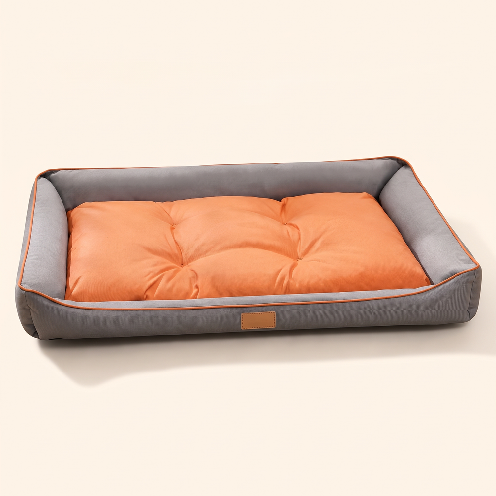 Large dog sofa bed with grey walls and orange cushion