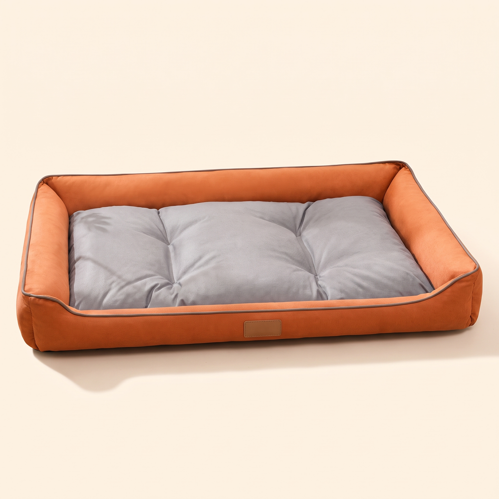 Large dog sofa bed with orange walls and grey cushion