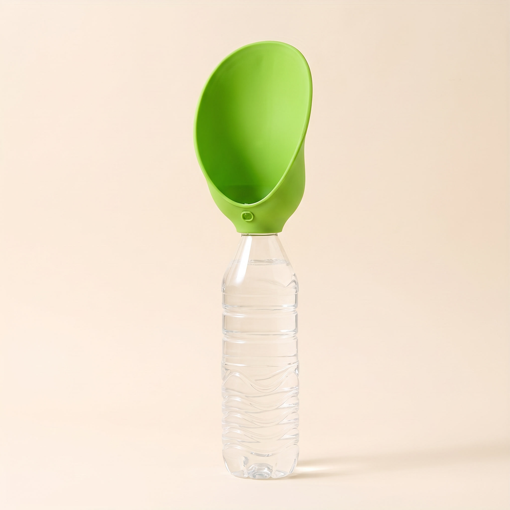 Green silicone dog drinking tray opened as a scoop on top of the bottle