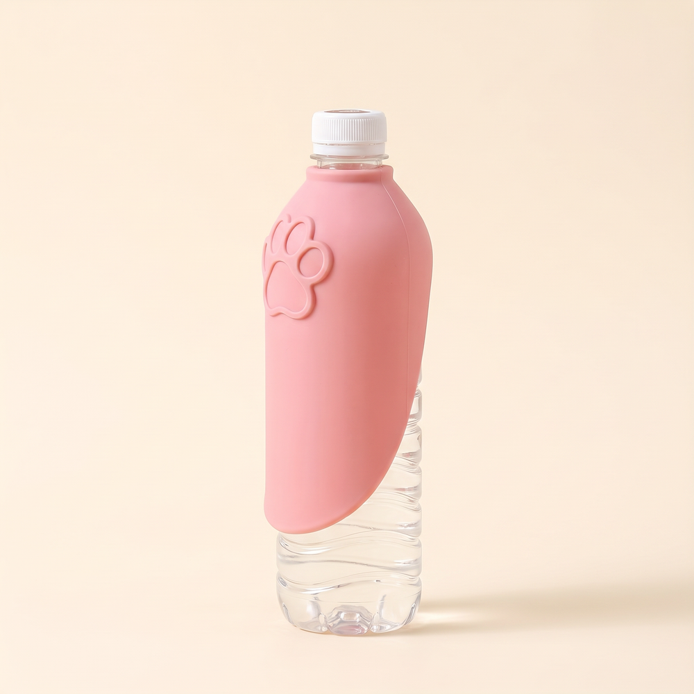 Pink silicone dog drinking tray folded closed on a water bottle