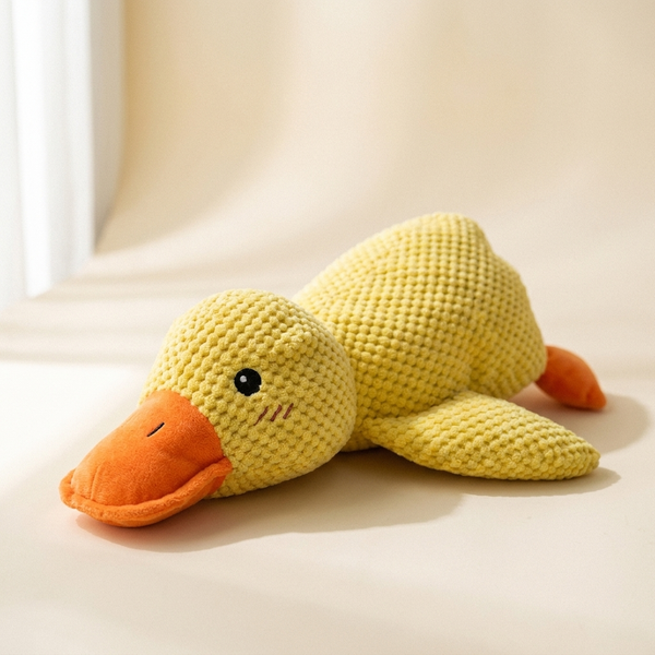 Calming duck squeaky plush dog toy on cream studio background