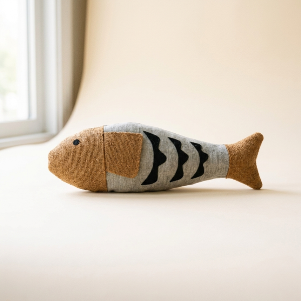 Crinkle fish cat kicker toy with bell on cream studio background