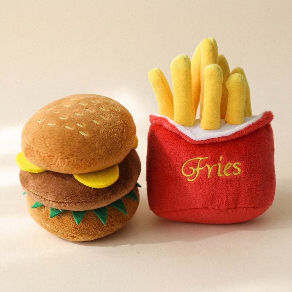 Fast food squeaky plush dog toy set with fries and burger on cream studio background