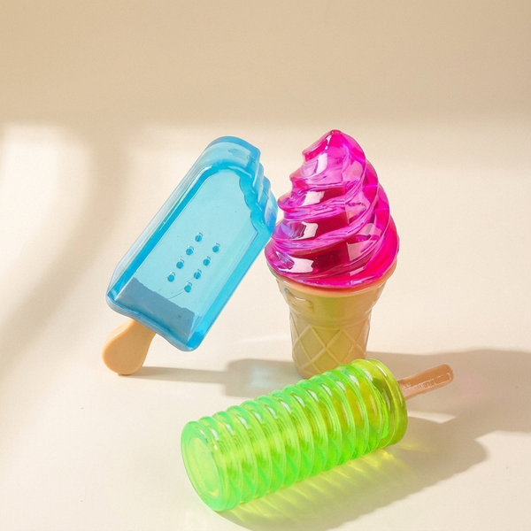 Freezable ice cream chew toy for dogs on cream studio background