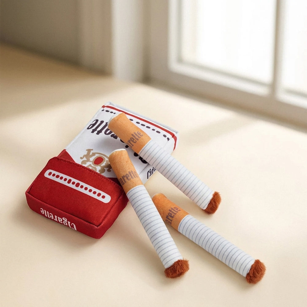 Funny cigar plush dog toy on cream studio background