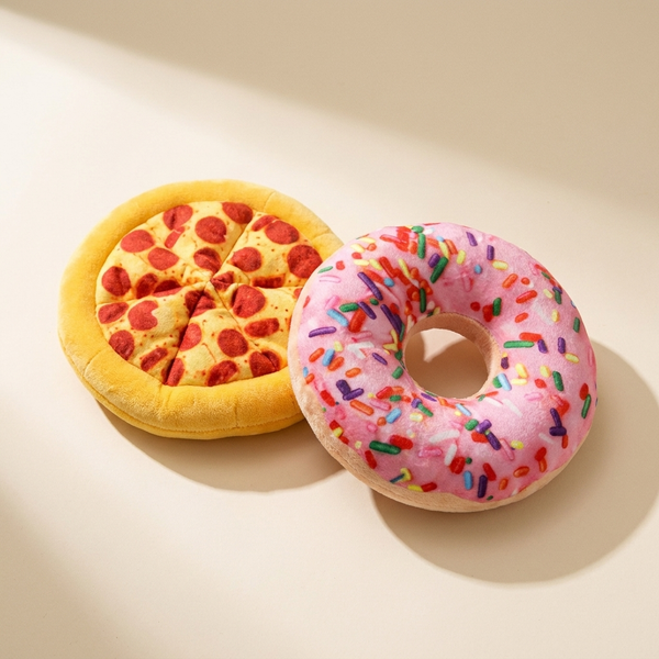 Squeaky pizza plush dog toy set on cream studio background