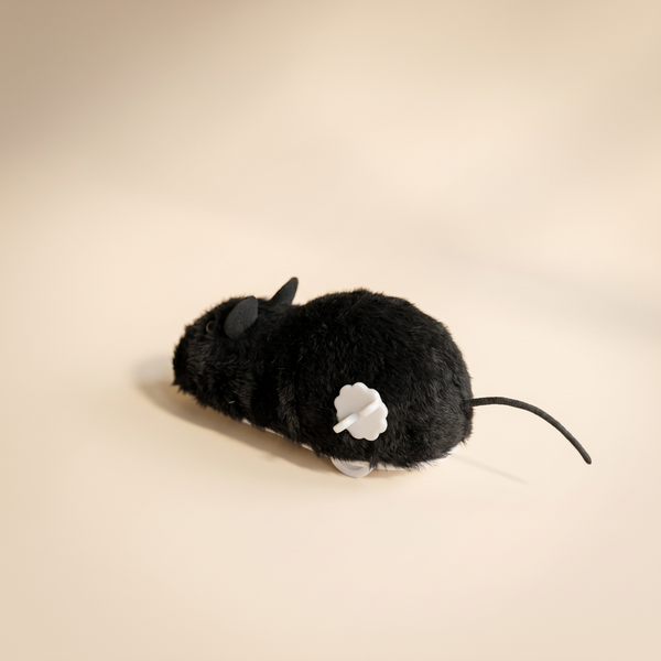 Wind-up plush mouse cat toy seen from the back, showing the white wind-up key and tail