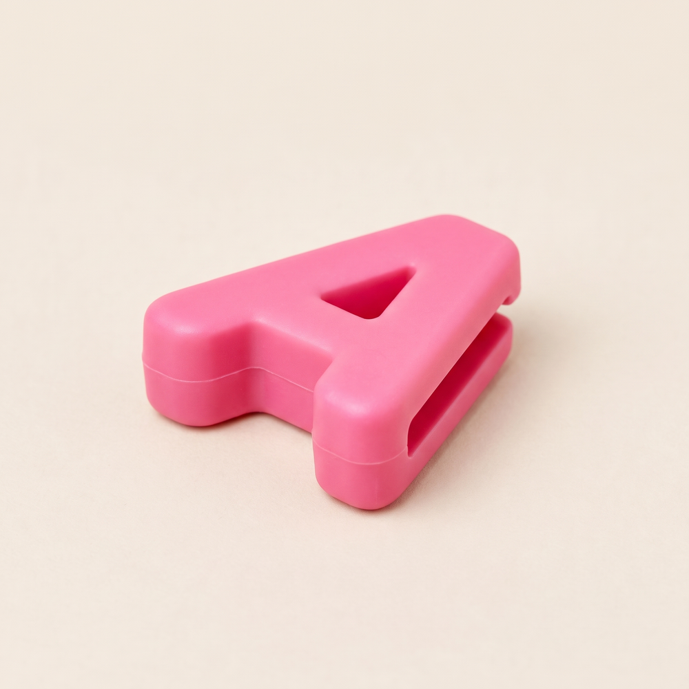 Single silicone name charm showing the threading slot - second angle