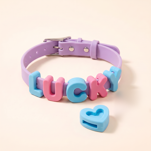 Silicone dog collar in lavender with LUCKY spelled in pink and blue letter charms and a blue heart charm
